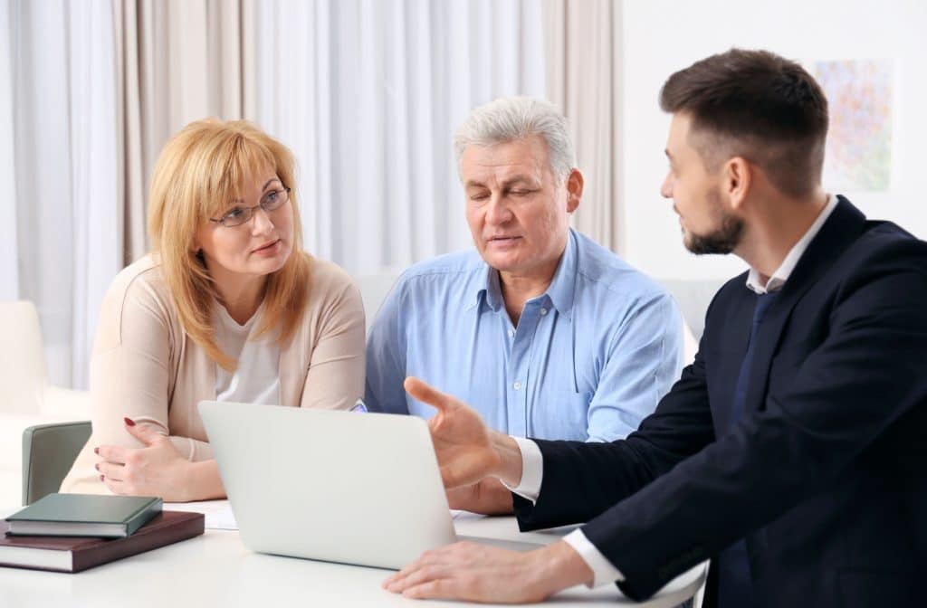 An adult and their senior parent discuss POA options with a lawyer.