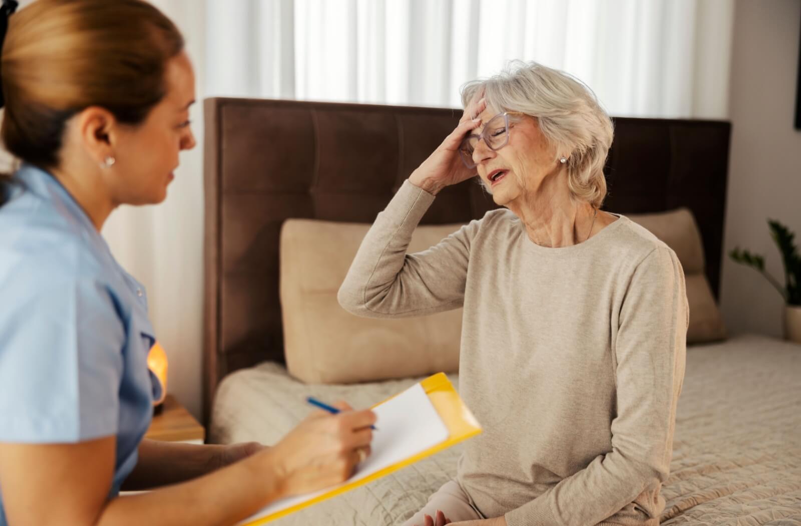 A senior in assisted living discusses their health with a skilled medical professional.
